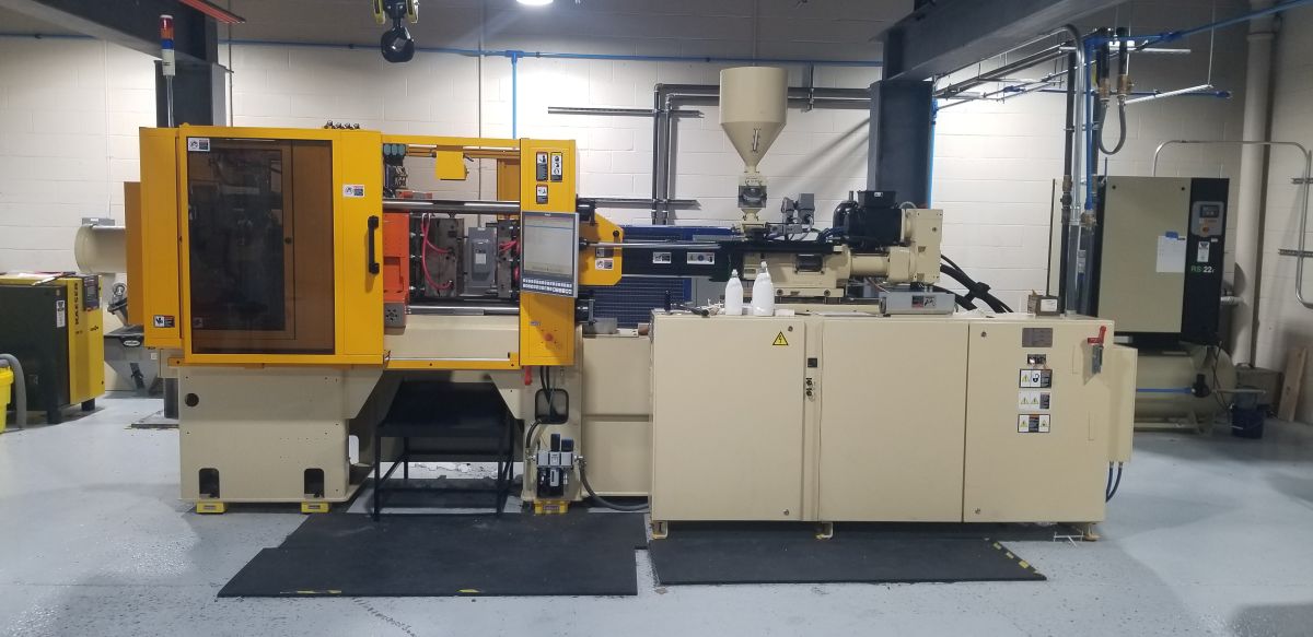 The image shows a horizontal plastic injection molding machine, appearing to resemble a Husky S-series model.